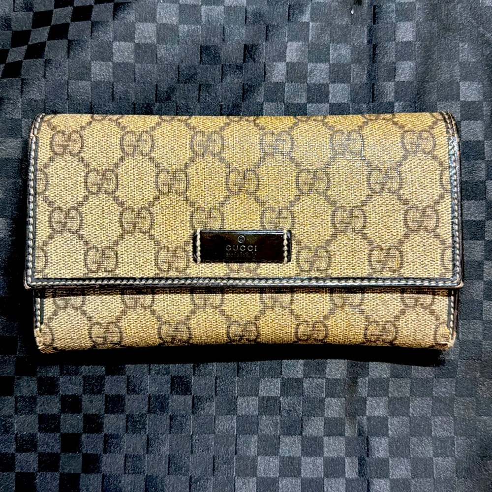 Authentic GUCCI brown and tan monogram coated canvas and leather snap wallet.